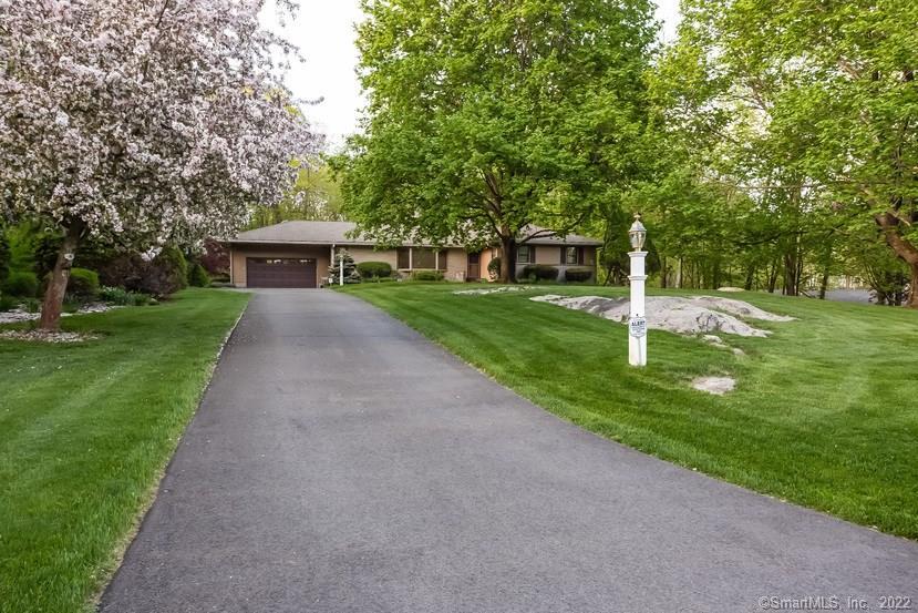 7 Sunbrook Road Woodbridge, CT 06525 - Photo 1 of 1 a front view of a house with garden