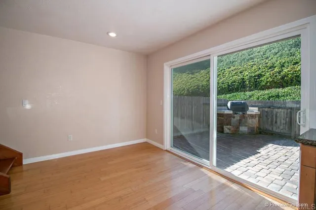 a room with wooden floor and outdoor view