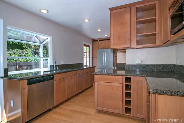 a kitchen with stainless steel appliances granite countertop a stove and a sink