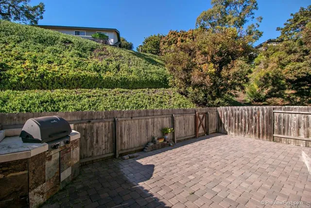 a view of a backyard with wooden fence