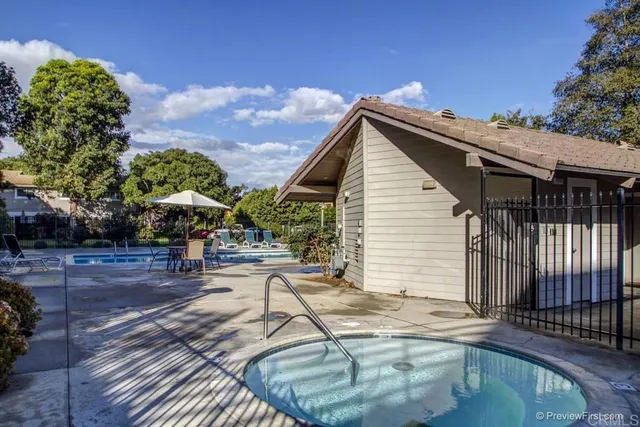 a view of a house with backyard and sitting area