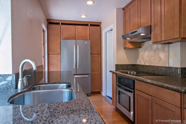 a kitchen with granite countertop a stove and a sink