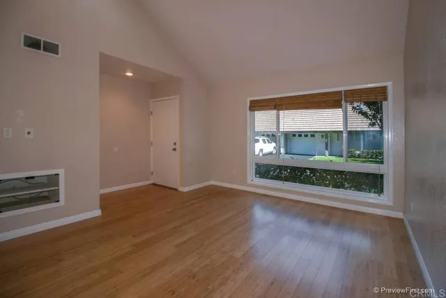 wooden floor in an empty room with a window