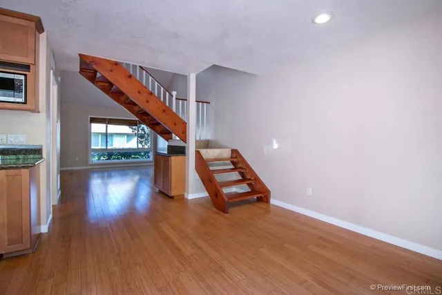 a view of entryway and hall with wooden floor