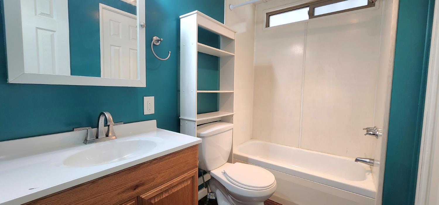 1300 West Olson Avenue, Unit 179 Reedley, CA 93654 - Photo 22 of 39 a bathroom with a sink a toilet and shower