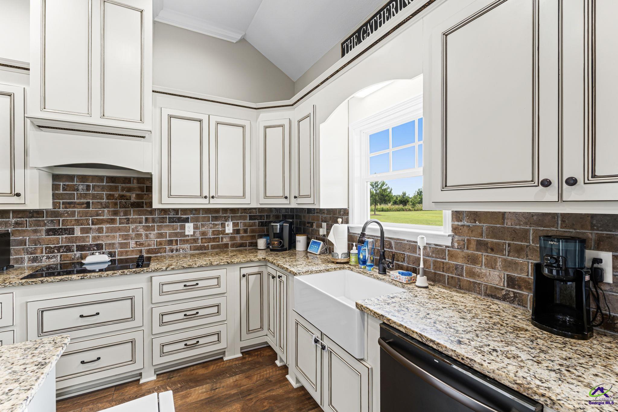 180 Woodland Trail Road Cochran, GA 31014 - Photo 11 of 25 a kitchen with granite countertop a sink a stove and cabinets