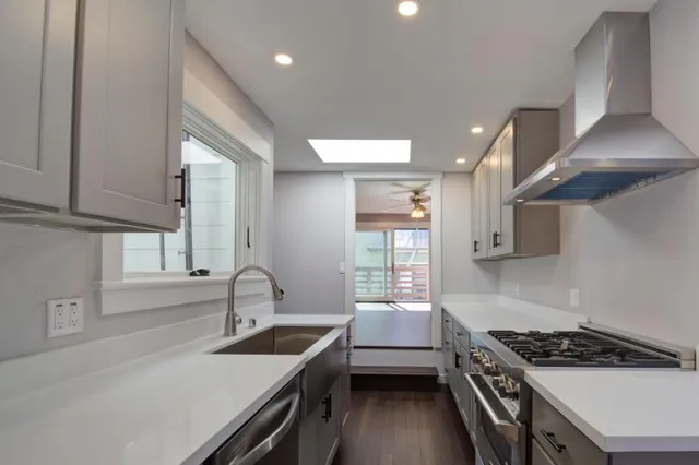 a bathroom with a sink a mirror and a window