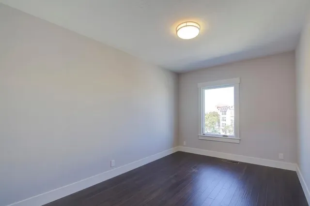 a view of a livingroom with a hardwood floor and a ceiling fan
