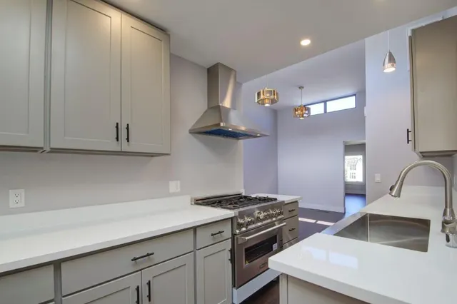 a bathroom with a sink a toilet a mirror and a window