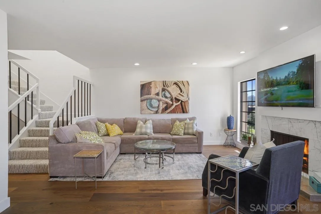 a living room with fireplace furniture and a flat screen tv