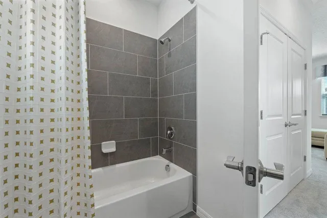 a bathroom with a bathtub and a shower