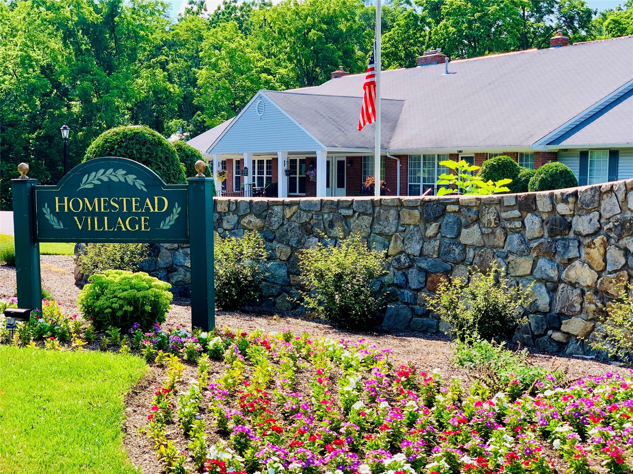 a front view of a house with a yard and fountain