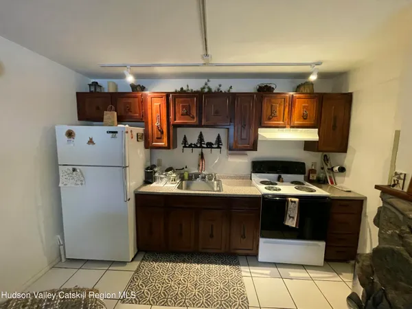 a kitchen with refrigerator and cabinets