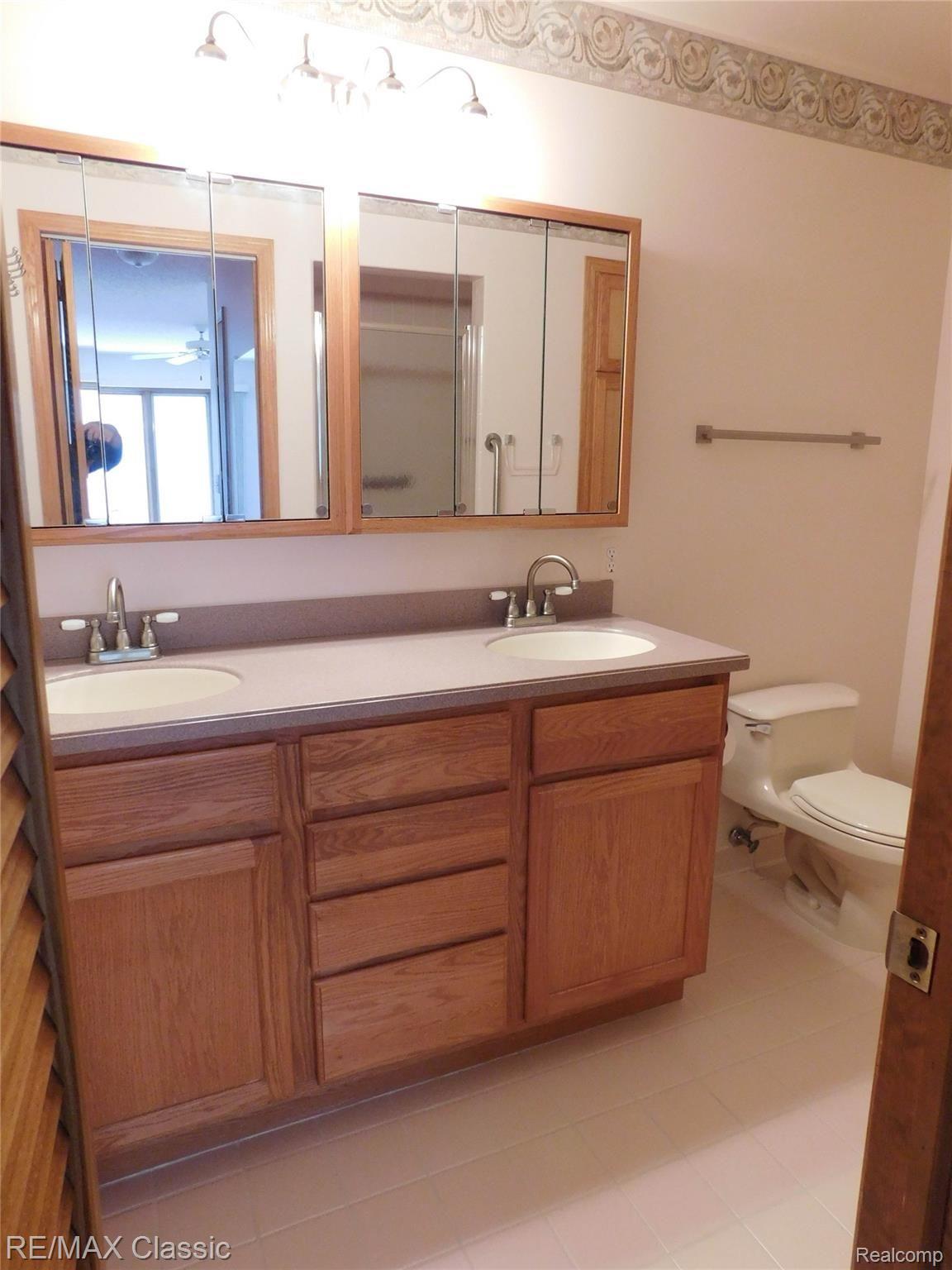 21840 River Ridge Trail, Unit 104 Farmington, MI 48335 - Photo 17 of 35 MASTER BATH WITH DOUBLE SINKS, CERAMIC TILE, STALL SHOWER