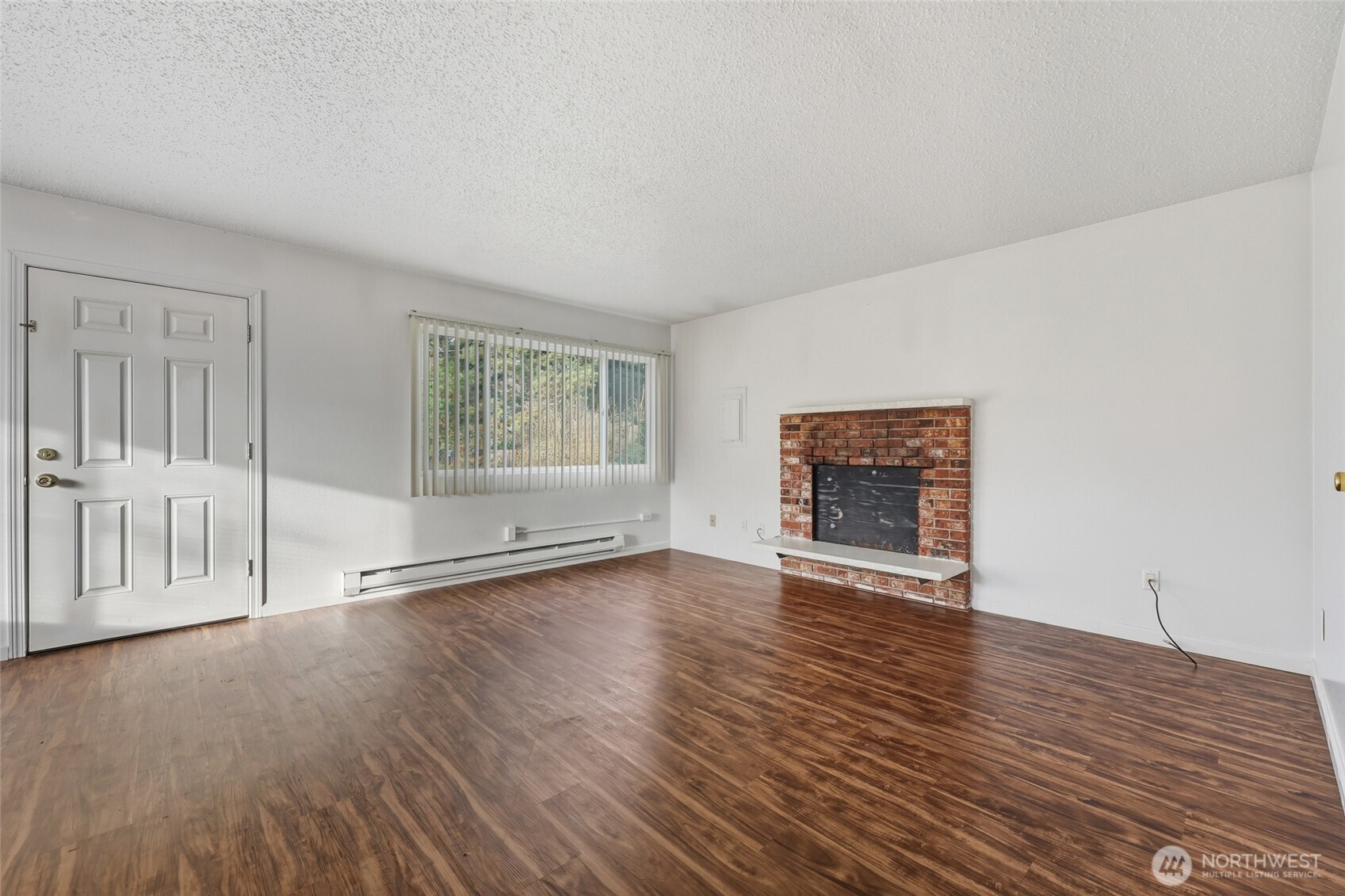 418 North 13th Street Elma, WA 98541 - Photo 11 of 37 a view of an empty room with wooden floor and a window