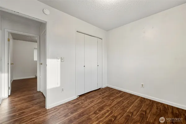 a view of a room with wooden floor