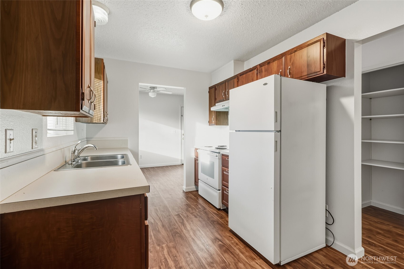 418 North 13th Street Elma, WA 98541 - Photo 8 of 37 a white refrigerator freezer sitting inside of a kitchen