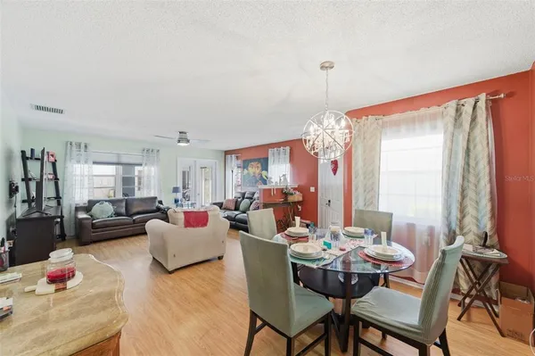a kitchen with stainless steel appliances a stove a sink cabinets and a dining table