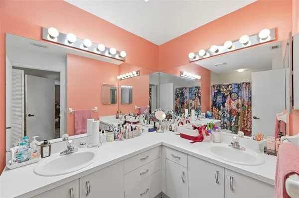 a white toilet sitting next to a bathroom sink and vanity