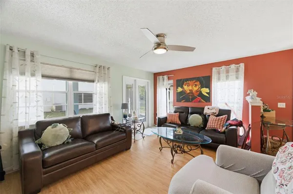 a view of a dining room with furniture wooden floor and chandelier