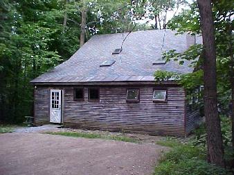 a view of house with backyard and garden