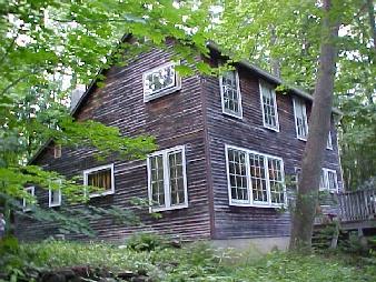 1324 Fred Snow Road Becket, MA 01223 - Photo 2 of 2 a brick house with a large windows