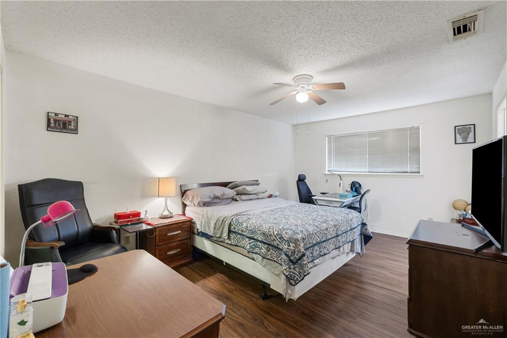 500 East El Rancho Avenue, Unit 22 McAllen, TX 78503 - Photo 11 of 17 a bedroom with a bed and a flat screen tv