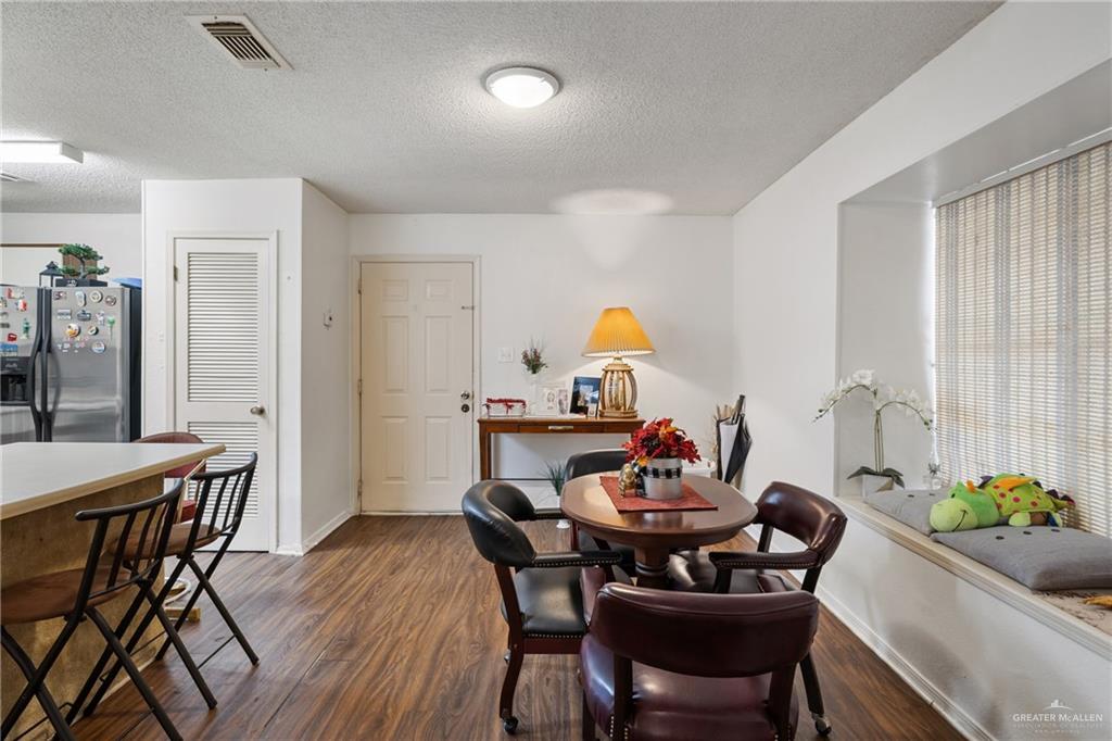 500 East El Rancho Avenue, Unit 22 McAllen, TX 78503 - Photo 9 of 17 a view of a dining room and livingroom with furniture wooden floor and a rug
