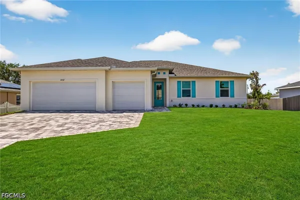 a front view of house with yard and green space