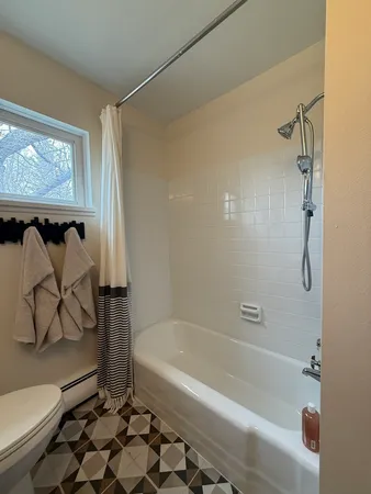 a bathroom with a granite countertop bathtub and a shower