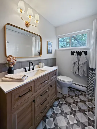 a bathroom with a sink toilet and a mirror