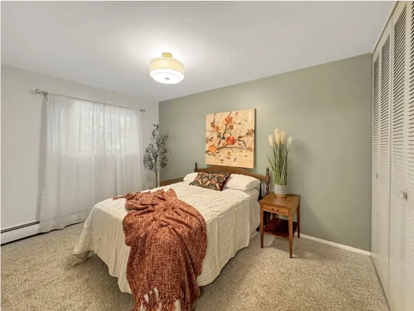 a spacious bedroom with a bed and a chandelier