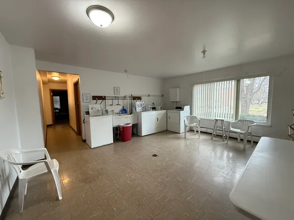 a living room with furniture and kitchen view
