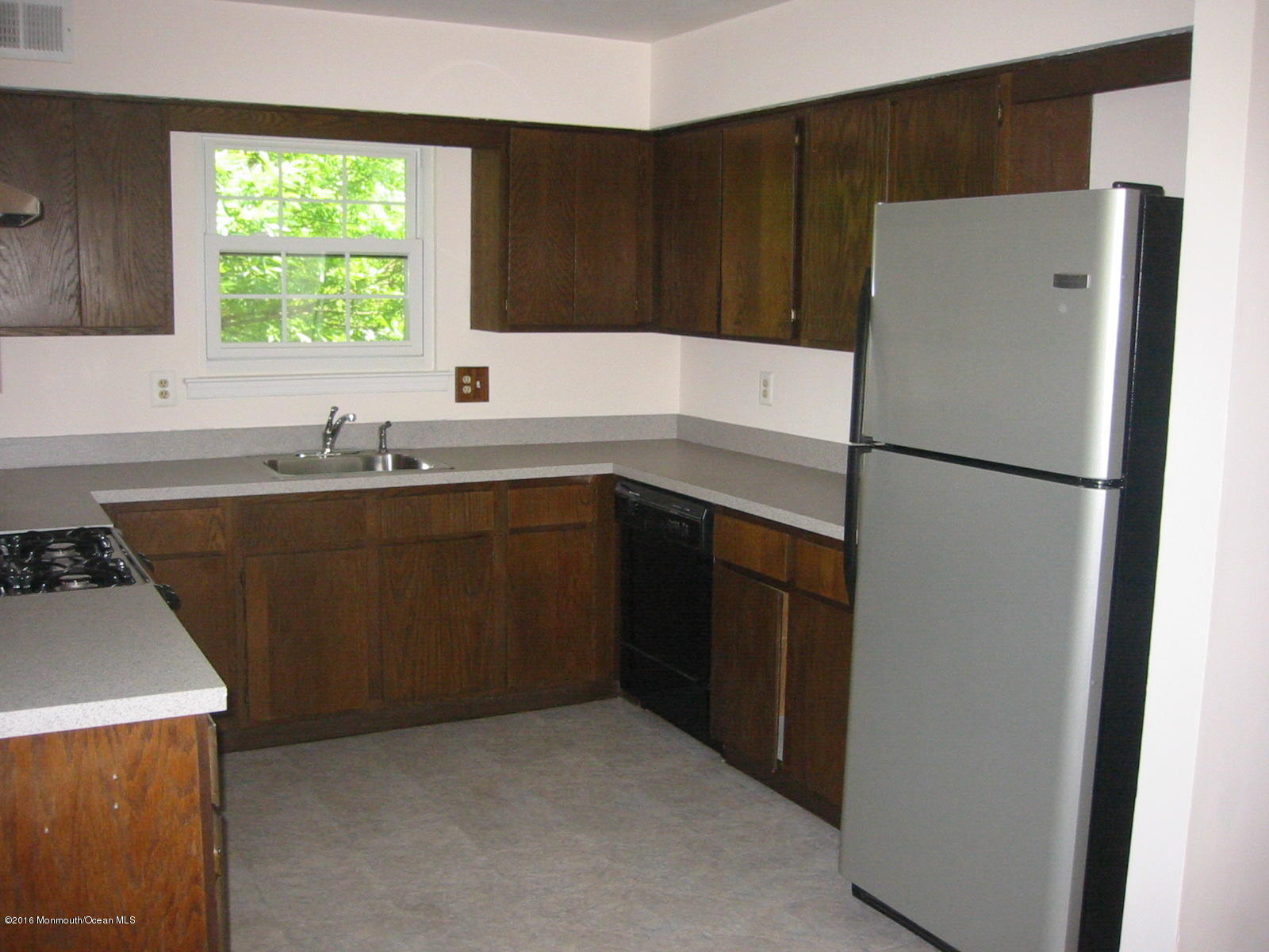 75 Appletree Road Howell, NJ 07731 - Photo 11 of 23 a white refrigerator freezer sitting inside of a kitchen with stainless steel appliances granite countertop cabinets and a sink