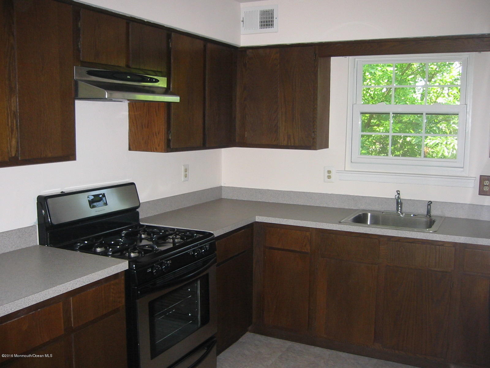 75 Appletree Road Howell, NJ 07731 - Photo 10 of 23 a kitchen with a sink stove top oven and cabinets