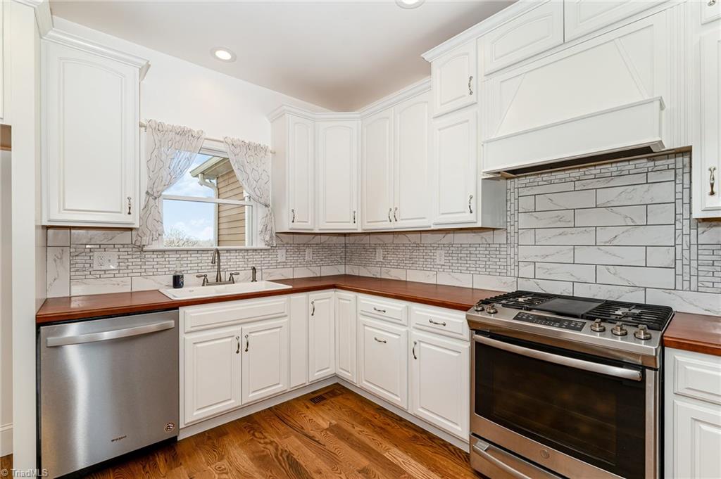 5518 Watchtower Road Julian, NC 27283 - Photo 13 of 50 Stainless steel appliances, custom tile backsplash, and soft close cabinets.