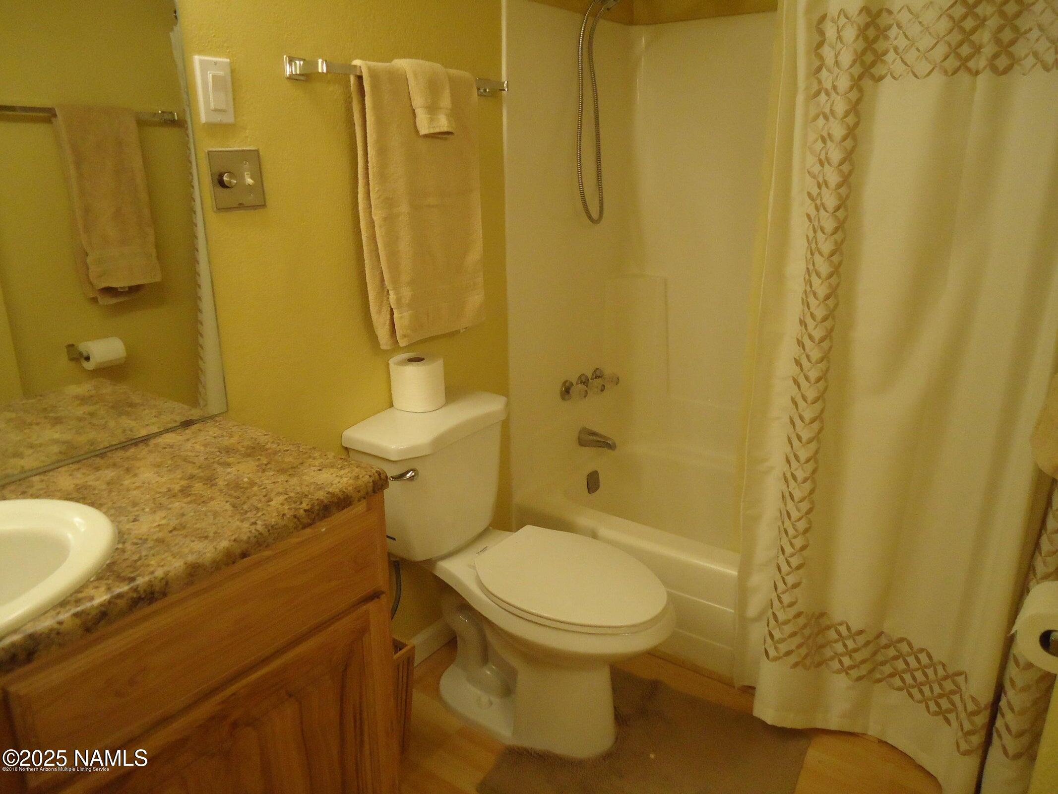 17980 Walapai Road, Unit 22B Munds Park, AZ 86017 - Photo 6 of 20 a bathroom with a granite countertop toilet and sink