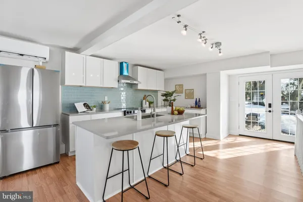 a kitchen with sink cabinets and wooden floor