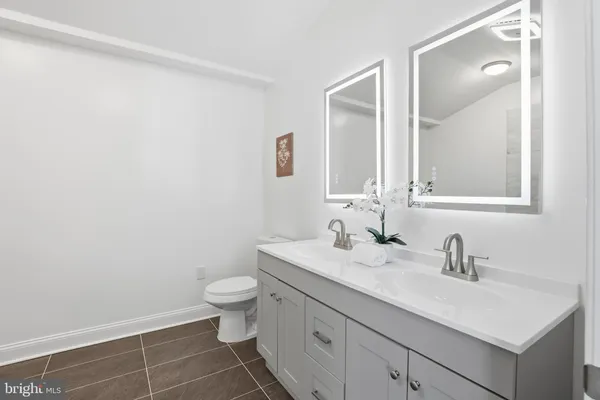 a view of a big room with wooden floor and windows