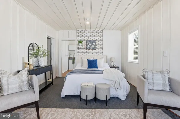a bathroom with a granite countertop toilet sink and mirror