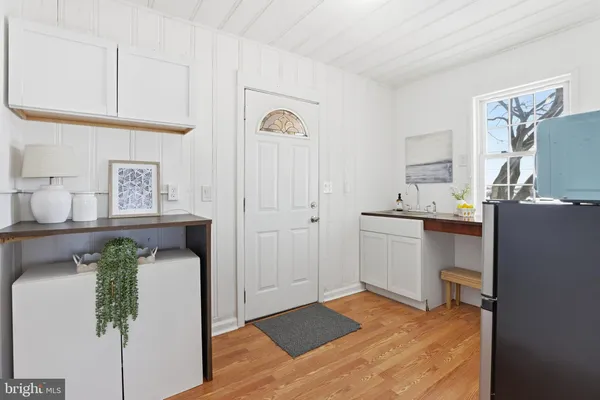 a view of a backyard with plants and large tree