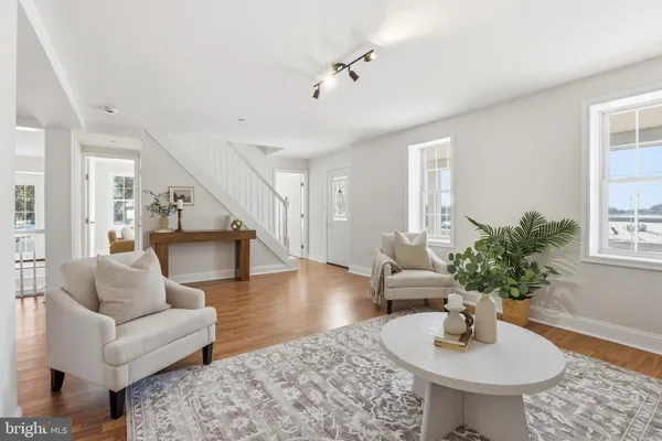 a living room with furniture potted plant and windows