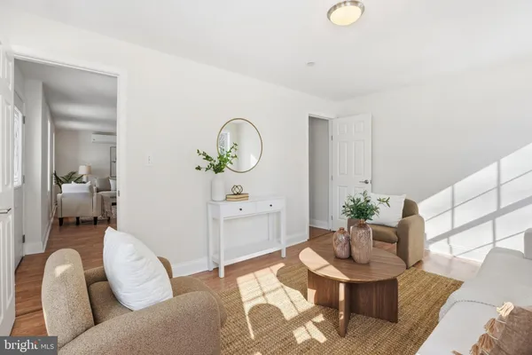 a living room with furniture a mirror and a window