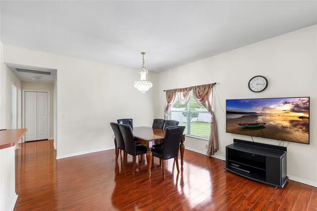 a view of a dining room with furniture window and wooden floor