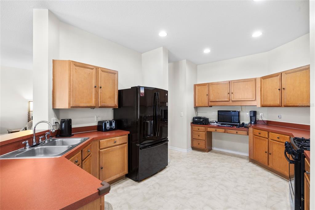 2763 Valencia Grove Drive Valrico, FL 33596 - Photo 16 of 38 a kitchen with a refrigerator stove top oven a sink and dishwasher