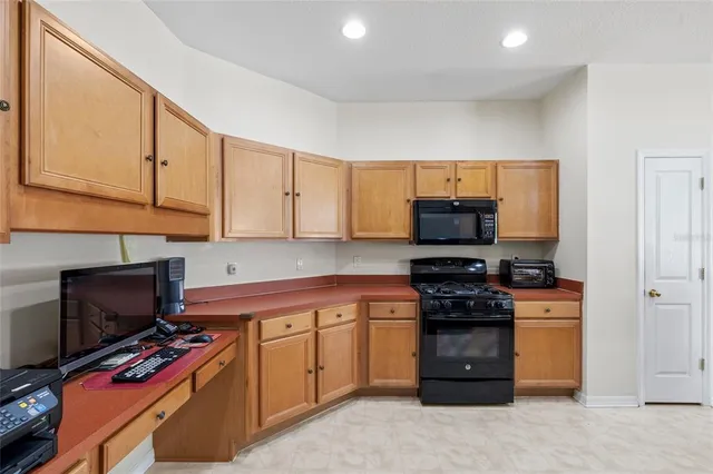 a kitchen with stainless steel appliances a stove a sink and a microwave