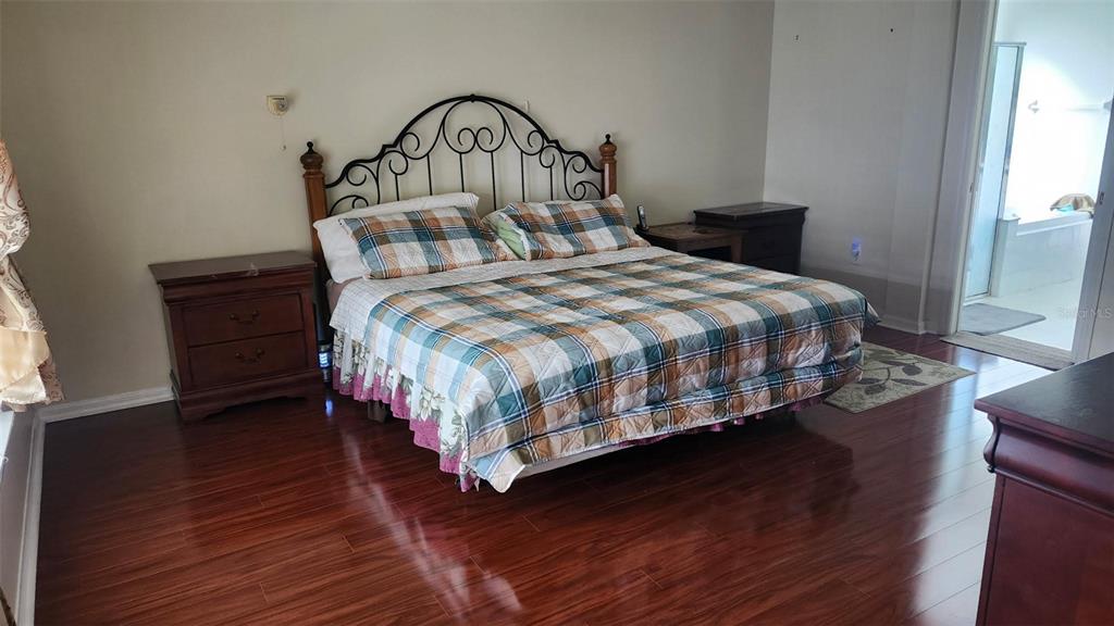 2763 Valencia Grove Drive Valrico, FL 33596 - Photo 20 of 38 a bedroom with a bed a dresser and a window