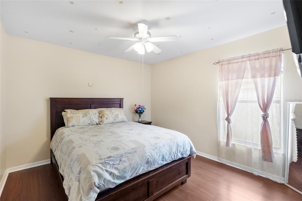 2763 Valencia Grove Drive Valrico, FL 33596 - Photo 28 of 38 a bedroom with a large bed and a window