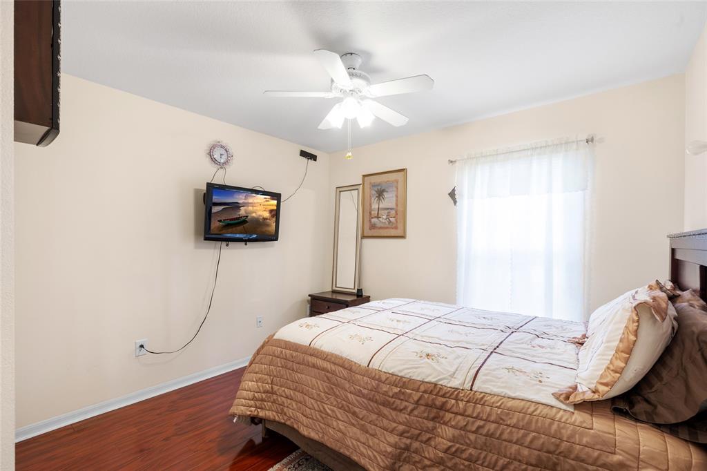 2763 Valencia Grove Drive Valrico, FL 33596 - Photo 31 of 38 a bedroom with a bed and a flat screen tv