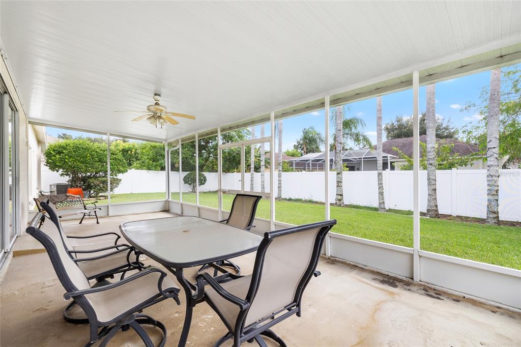 2763 Valencia Grove Drive Valrico, FL 33596 - Photo 32 of 38 a view of a patio with a table chairs and a swimming pool